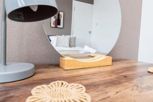 a bedroom with a bed and a mirror on a wooden floor at Enchanting 4 spacious bedrooms in Birmingham