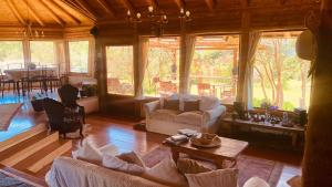 a living room with couches and a table in a room at Casona Ser in Pucón