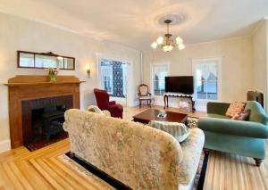 a living room with a couch and a fireplace at The Bartlett Village House in Bartlett
