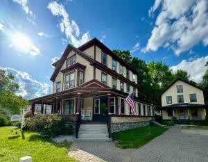 a house with an american flag in front of it at The Bartlett Village House in Bartlett