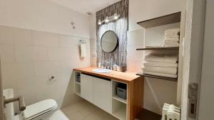 a bathroom with a sink and a toilet and a mirror at Aiila House in Esquel +40 photos