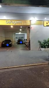 a parking garage with two cars parked in it at Hospedaria Monumento in Sao Paulo