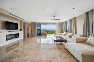 a living room with two couches and a tv at Hillside Hideaway - Hinterland Escape with Panoramic Views in Woombye