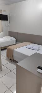 Postel nebo postele na pokoji v ubytování Hotel Andorinha