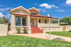 a white house with a lawn in front of it at Llewoh on Crofton in Echuca +18 photos