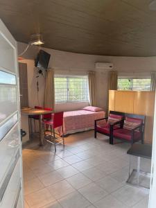 a room with a bed and a table and chairs at La Serena in Villa Carlos Paz