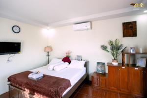 Ένα ή περισσότερα κρεβάτια σε δωμάτιο στο Villa Djona Syariah