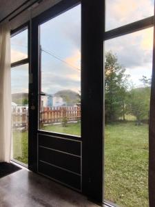 an open door with a view of a yard at Nuna Tiny House in El Chalten +11 photos