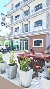 a table and benches in front of a building at Baan Samrarn in Krabi town