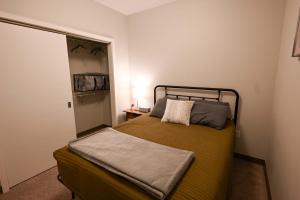 a small bedroom with a bed with a mirror at 2 Bedroom Brand New Apartment Near Mayo, Park Free in Rochester +21 photos