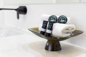 a towel rack with towels on it in a bathroom at Shoreline Luxe - Refined Beachside Elegance with Spa in Caves Beach