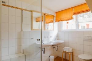 une salle de bain avec un lavabo et une douche dans l'établissement Ferienhaus Emil, à Meersburg 10 autres photos