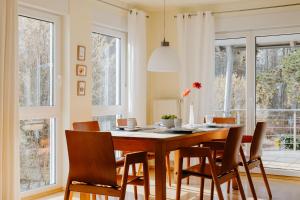 a dining room with a wooden table and chairs at Ferienhaus Emil in Meersburg