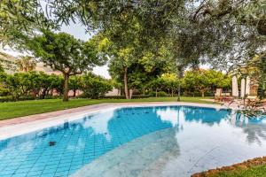 a swimming pool in a yard with trees at Villa Irlanda Grand Hotel in Gaeta