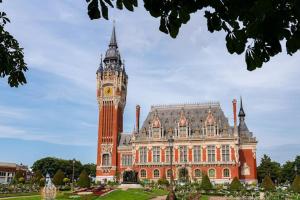 a large building with a clock tower in front of it at Les Appart'Hôtels Du Calaisis - 202 - Hyper centre & Proche plage in Calais