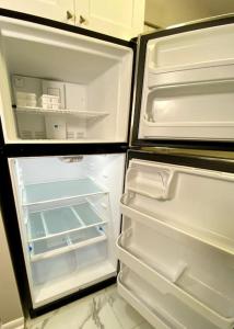 an empty refrigerator with its door open in a kitchen at Summer Bookings Available NOW! Going Fast! in Calabash