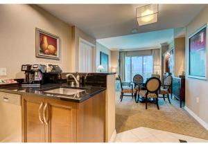 a kitchen with a sink and a living room at MGM Signature Top Floor 1 BR 2 BA Penthouse with Balcony, Strip and Sphere Views in Las Vegas