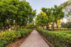 a path in a park with trees and flowers at Villa Irlanda Grand Hotel in Gaeta