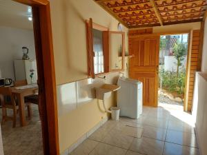 a kitchen with a sink and a small refrigerator at Cantinho do silêncio in Joinville