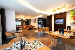a restaurant with tables and chairs and a bar at Platinum Residence in Dhaka
