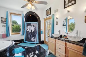 a bathroom with two sinks and a tub and a mirror at The Starlight Tower Hot Tub Suite with 8-Jet Massage Shower and Amazing Views in Fort Atkinson