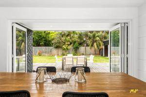 a dining room with a table and a patio at The Esplanade Indented Heads- Beach front, Luxury, Sleeps 8, Spacious, Aircon, Heating, in Indented Head