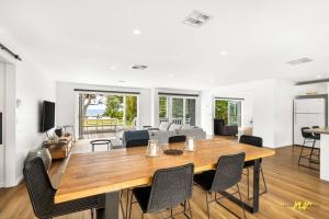 a dining room and living room with a table and chairs at The Esplanade Indented Heads- Beach front, Luxury, Sleeps 8, Spacious, Aircon, Heating, in Indented Head