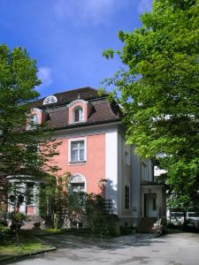 a large house with a red and white at Hotel Galleria in Munich