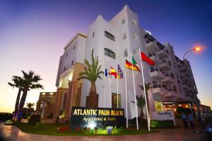 a building with flags in front of it at Atlantic Palm Beach in Agadir