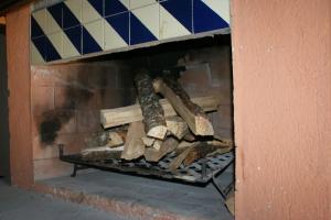 a pile of wood on a shelf in a fireplace at Cabaña El Tigrito in Quiroga