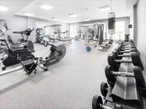 a gym with several treadmills and machines at Royal Manor- Marina Diamond 2 in Dubai