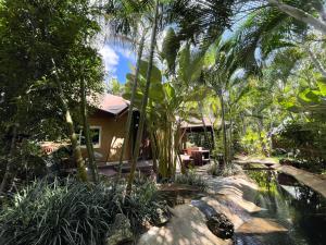 a house in the jungle with a pool and trees at River tales ริเวอร์เทลส์แก่งกระจาน in Phetchaburi
