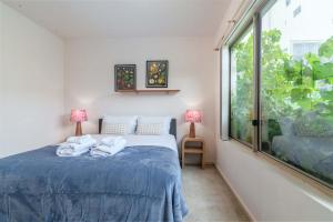 a bedroom with a bed with two towels on it at 2BR Urban Nest Cosy & Central - Free Parking in Adelaide