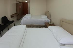A bed or beds in a room at Gizem Pansiyon