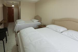 A bed or beds in a room at Gizem Pansiyon