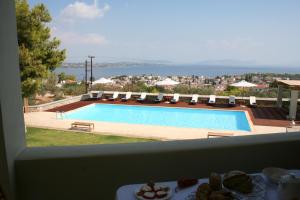 a view of a swimming pool from a balcony at Xenon Estate in Spetses