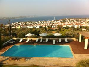 a swimming pool with a view of a city at Xenon Estate in Spetses