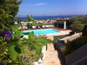 a swimming pool with a view of the ocean at Xenon Estate in Spetses