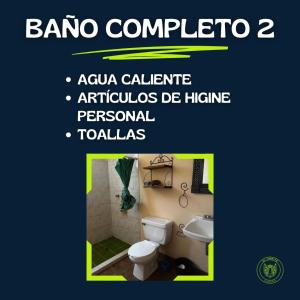 a bathroom with a toilet and a sink at Cabaña El Tigrito in Quiroga +29 photos