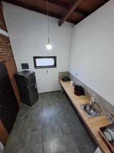 a kitchen with a sink and a counter top at Dambullawatha Bungalow Garden Villa in Hikkaduwa