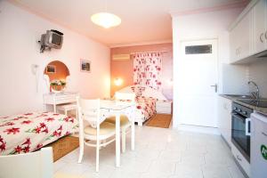a kitchen and dining room with a table and chairs at Maria's Studios in Myrties