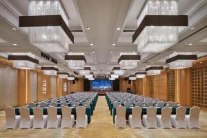 une salle de conférence avec des chaises et une scène dans l'établissement Yueyang Grand Skylight Hotel, à Yueyang