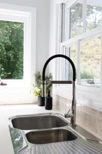 奥兰治Meadowbrook MTB Lodge Orange - Rip on the trails, sip on the wine!的厨房里设有厨房水槽和窗户 更多46张照片