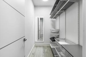 a white kitchen with a sink and a mirror at Chic & Cozy River District Townhouse in Fort Myers +15 photos