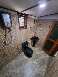 a bathroom with a toilet and a shower at Dambullawatha Bungalow Garden Villa in Hikkaduwa +65 photos