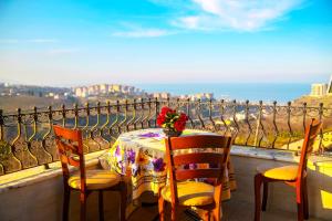 a table and chairs on a balcony with a view at Family Seaview Villa 1 in Trabzon