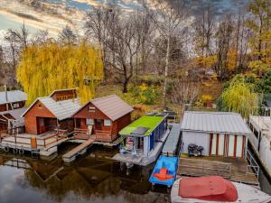 an aerial view of a house and a boat on the water at Houseboat Prague with Paddle Boat -Sail, Explore and Relax in Prague