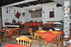 a restaurant with tables and chairs in a room at Family Hotel Alpin - 91 - 1 min walk to city centre in Bansko