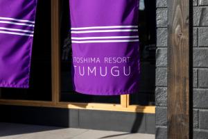 a purple towel is hanging in a window at 糸島 リゾート Tumugu in Fukuoka +4 photos