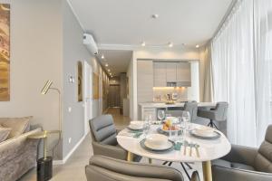 a dining room and kitchen with a table and chairs at Drusk Sun in Druskininkai